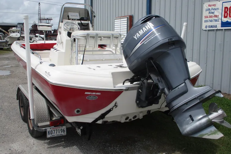 Slide: The Image of 2005 NauticStar 2200 NauticBay boat with Yamaha outboard motor, parked on a trailer. - 3