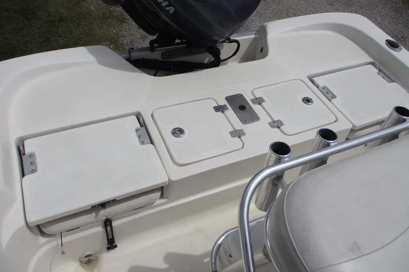 Slide: The Image of 2005 NauticStar 2200 NauticBay boat deck with storage compartments and rod holders. - 5