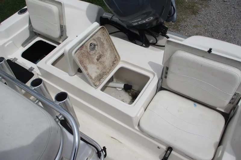 Slide: The Image of 2005 NauticStar 2200 NauticBay boat interior with storage compartments and seating. - 6