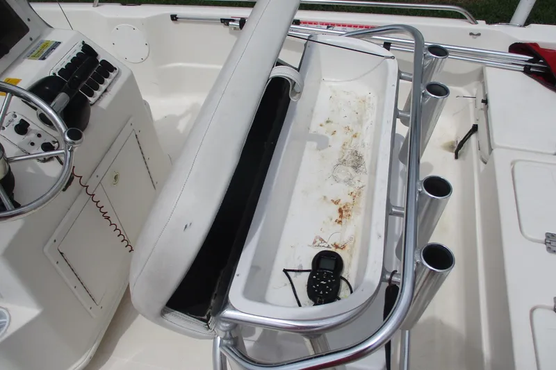 Slide: The Image of 2005 NauticStar 2200 NauticBay boat interior with steering console and rod holders. - 9