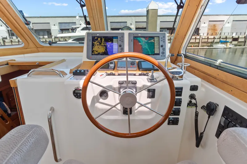 Slide: The Image of 2007 Sabre 42 Hard Top Express helm with navigation screens and wooden steering wheel. - 18