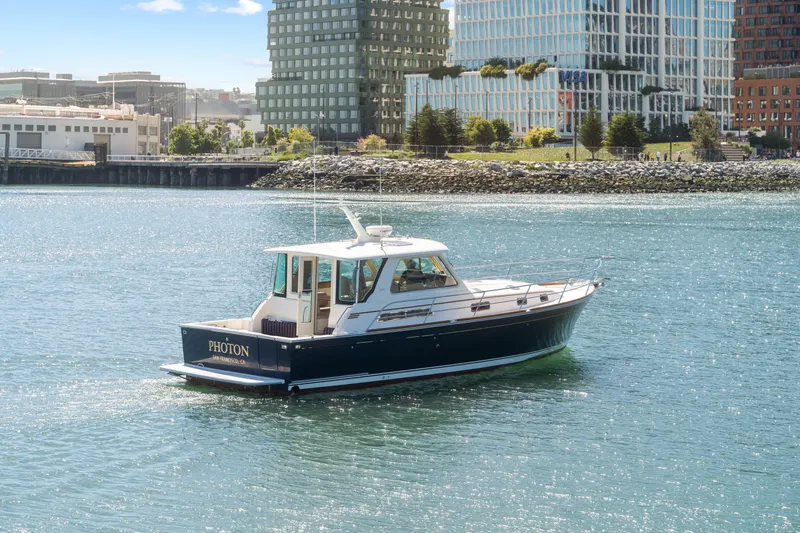 Slide: The Image of 2007 Sabre 42 Hard Top Express yacht cruising near urban waterfront. - 2