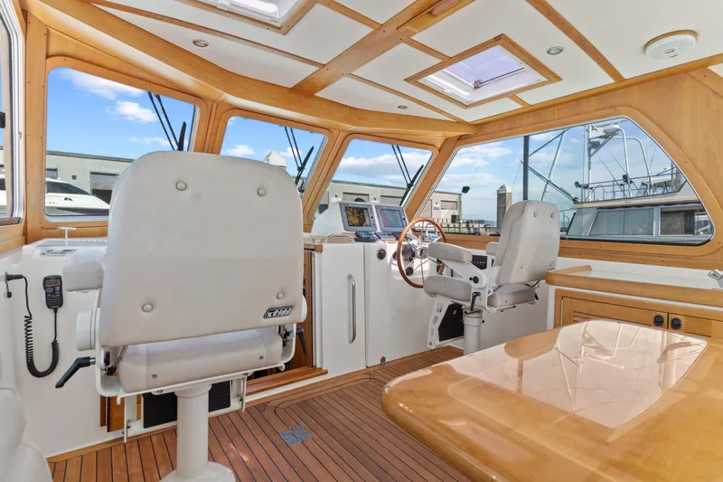 Slide: The Image of Interior of 2007 Sabre 42 Hard Top Express yacht with helm and seating area. - 21