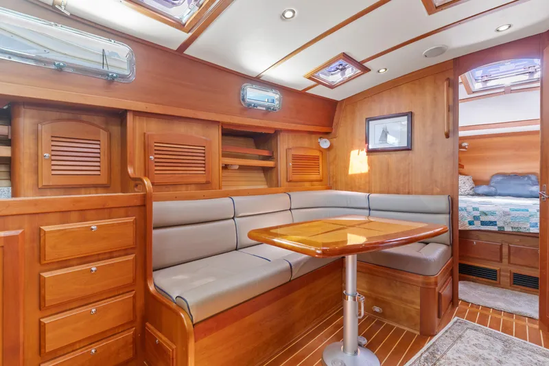Slide: The Image of 2007 Sabre 42 Hard Top Express interior with wooden cabinetry and cozy seating area. - 23