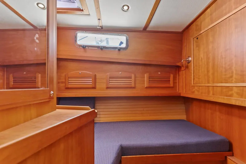 Slide: The Image of 2007 Sabre 42 Hard Top Express cabin with wooden interior and cozy bed. - 25
