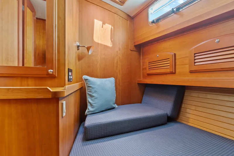 Slide: The Image of 2007 Sabre 42 Hard Top Express cabin interior with wooden finish and blue cushion. - 27