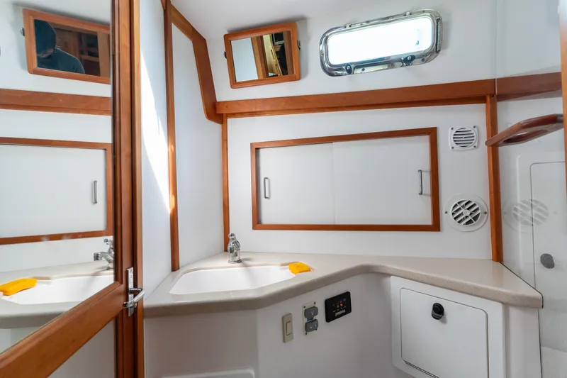 Slide: The Image of Bathroom interior of 2007 Sabre 42 Hard Top Express yacht, featuring wood accents and modern fixtures. - 31