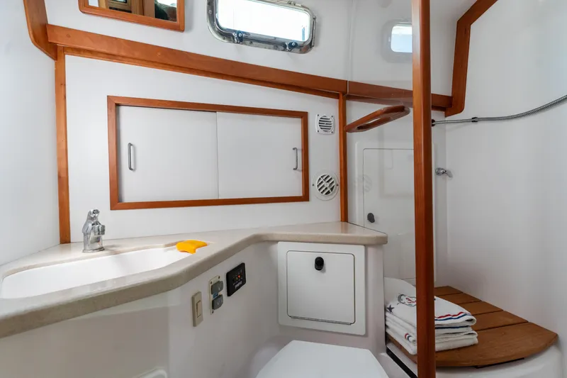 Slide: The Image of 2007 Sabre 42 Hard Top Express yacht bathroom with wood accents and modern fixtures. - 32