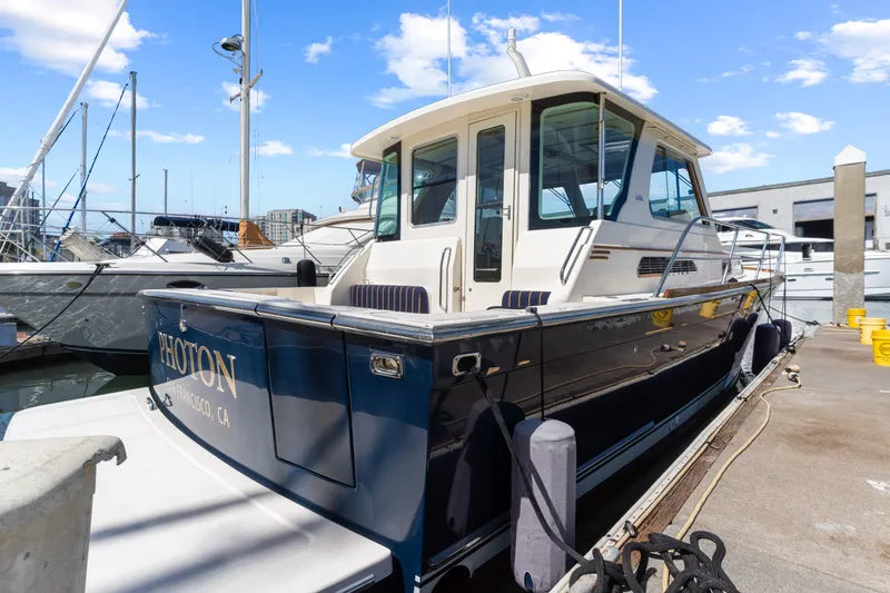 Slide: The Image of 2007 Sabre 42 Hard Top Express yacht docked at marina under blue sky. - 6