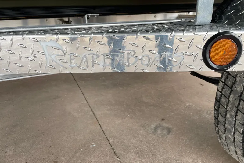 Slide: The Image of Reaper Boats 753 Timber Reaper 2026 trailer with diamond plate and orange reflector. - 11