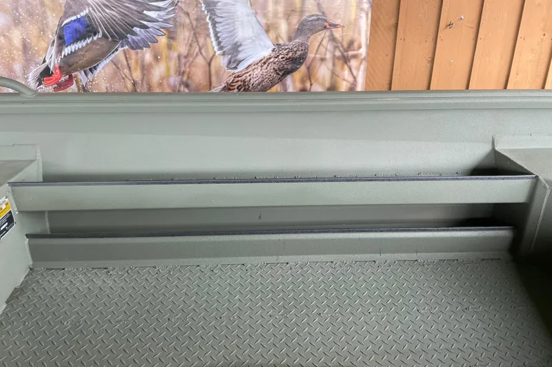 Slide: The Image of 2026 Reaper Boats 753 Timber Reaper interior with textured flooring and storage compartments. - 2