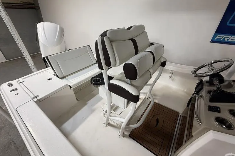 Slide: The Image of 2017 Crevalle 26 HCO boat interior with dual seats and steering console. - 6