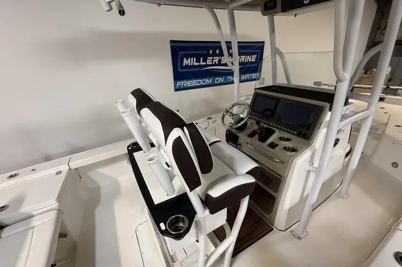Slide: The Image of 2017 Crevalle 26 HCO boat interior with helm, seating, and navigation equipment. - 9