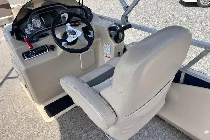 Slide: The Image of 2015 Sun Tracker Fishin' Barge 24 DLX helm with steering wheel and gauges. - 10