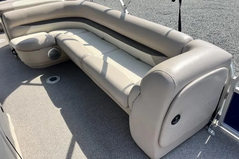Slide: The Image of 2015 Sun Tracker Fishin' Barge 24 DLX interior seating with beige upholstery. - 11