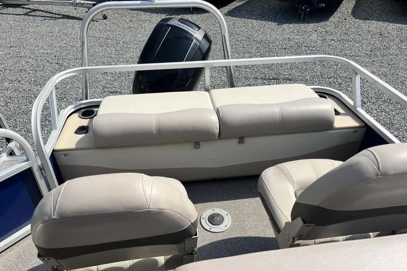 Slide: The Image of 2015 Sun Tracker Fishin' Barge 24 DLX interior with seating and motor view. - 13