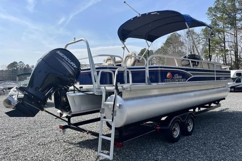 Slide: The Image of 2015 Sun Tracker Fishin' Barge 24 DLX pontoon boat on trailer with canopy and outboard motor. - 3