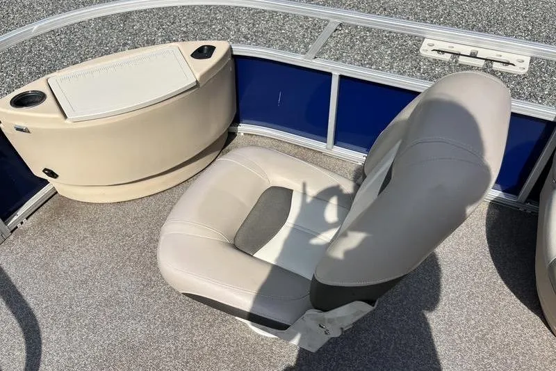 Slide: The Image of 2015 Sun Tracker Fishin' Barge 24 DLX interior with seating and storage compartment. - 5
