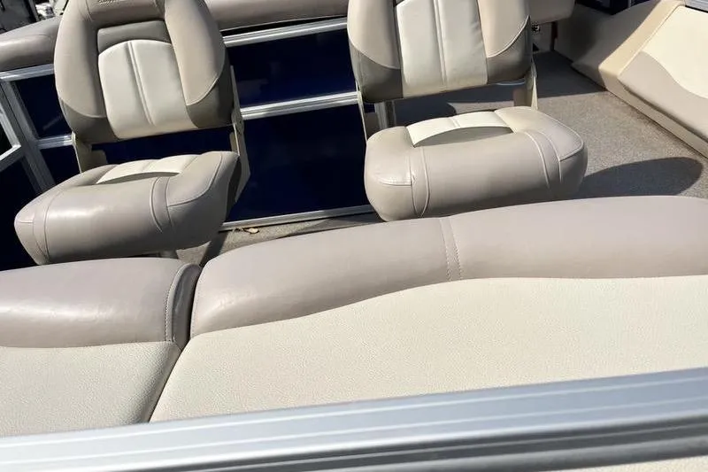Slide: The Image of 2015 Sun Tracker Fishin' Barge 24 DLX interior seating with beige upholstery. - 9