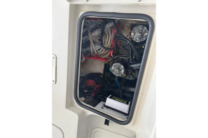 Slide: The Image of 2011 Pathfinder 2200 Tournament Edition boat compartment with ropes and wiring. - 13