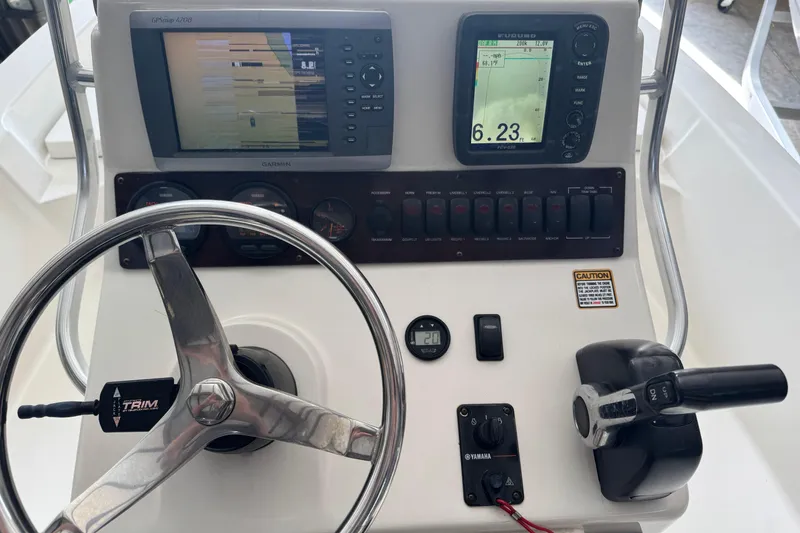 Slide: The Image of Steering console of 2011 Pathfinder 2200 Tournament Edition boat with navigation equipment. - 17