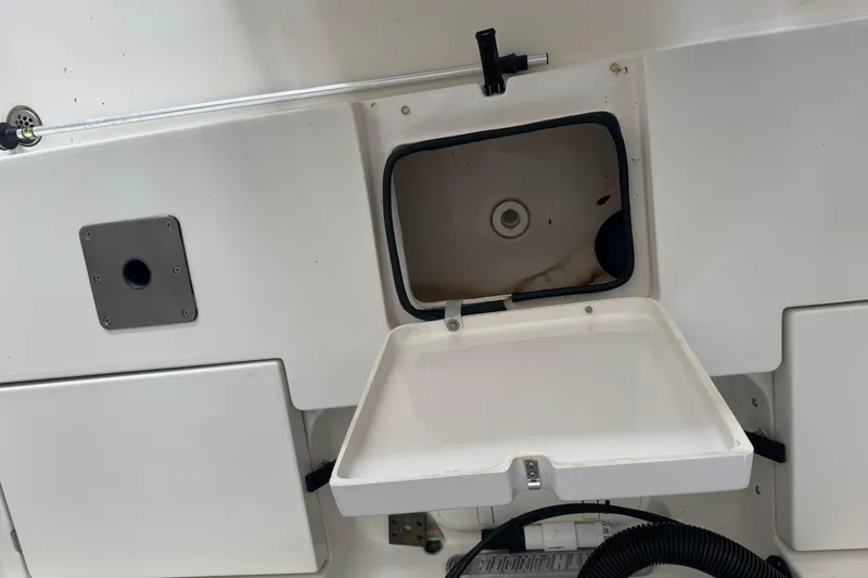 Slide: The Image of 2011 Pathfinder 2200 Tournament Edition boat storage compartment with open hatch. - 23