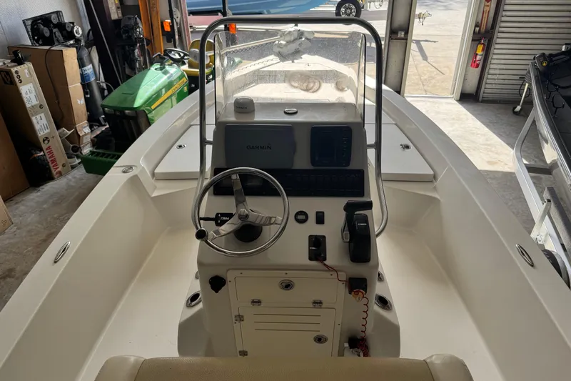 Slide: The Image of 2011 Pathfinder 2200 Tournament Edition boat interior with steering console in a garage. - 24
