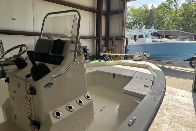 Slide: The Image of 2011 Pathfinder 2200 Tournament Edition boat in a garage, with another boat outside. - 4