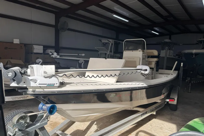 Slide: The Image of 2011 Pathfinder 2200 Tournament Edition boat in storage, featuring a trolling motor. - 9