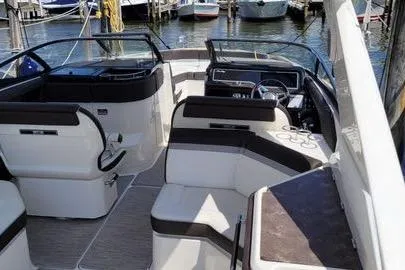 Slide: The Image of 2017 Sea Ray SLX 310 boat interior with seating, docked at marina. - 11