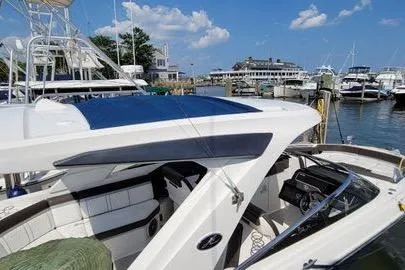 Slide: The Image of 2017 Sea Ray SLX 310 boat docked at a marina under a clear blue sky. - 12