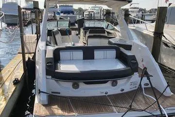 Slide: The Image of 2017 Sea Ray SLX 310 boat docked at marina, featuring spacious seating and sleek design. - 3