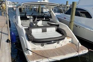 Slide: The Image of 2017 Sea Ray SLX 310 boat docked at marina, featuring spacious seating and sleek design. - 5