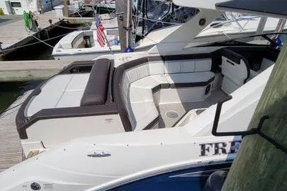 Slide: The Image of 2017 Sea Ray SLX 310 boat docked, featuring spacious seating and sleek design. - 7