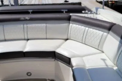 Slide: The Image of 2017 Sea Ray SLX 310 boat interior with white and black seating. - 9