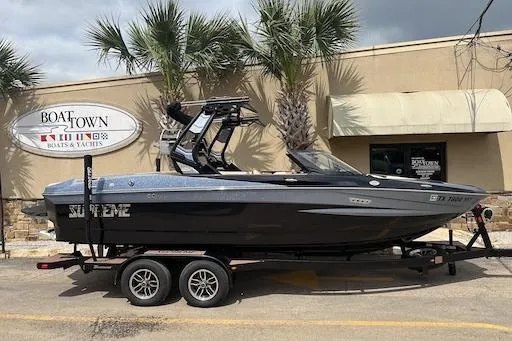 The Image of 2024 Supreme S220 boat on trailer at Boat Town dealership. - 0