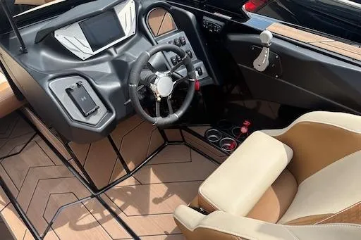 Slide: The Image of 2024 Supreme S220 boat interior with modern dashboard and luxurious seating. - 11