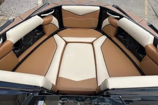 Slide: The Image of 2024 Supreme S220 boat interior with brown and cream seating. - 12