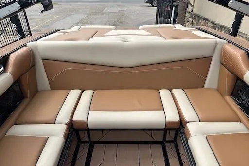 Slide: The Image of 2024 Supreme S220 boat interior with tan and cream seating, showcasing luxury design. - 16