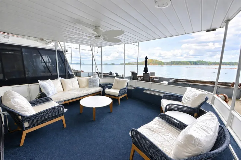 Slide: The Image of Spacious deck on 1998 Stardust Cruisers 16x84 houseboat with comfortable seating and scenic lake view. - 1