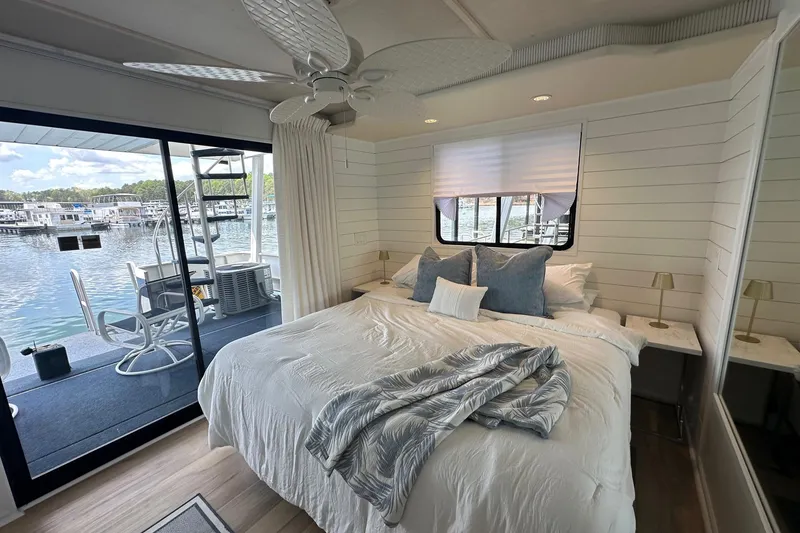 Slide: The Image of Cozy bedroom on 1998 Stardust Cruisers 16x84 houseboat with lake view and modern decor. - 11