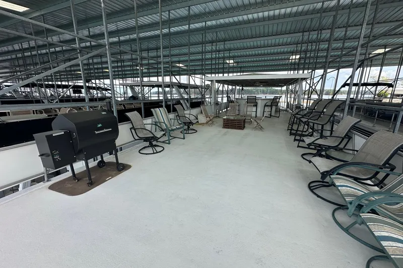 Slide: The Image of Spacious deck of 1998 Stardust Cruisers 16x84 houseboat with seating and grill. - 14