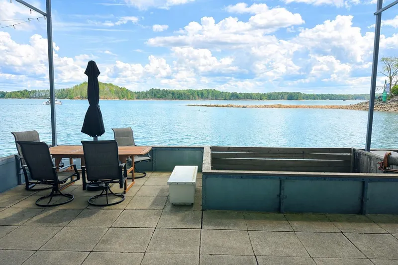 Slide: The Image of Outdoor deck on 1998 Stardust Cruisers houseboat with lake view and patio furniture. - 15