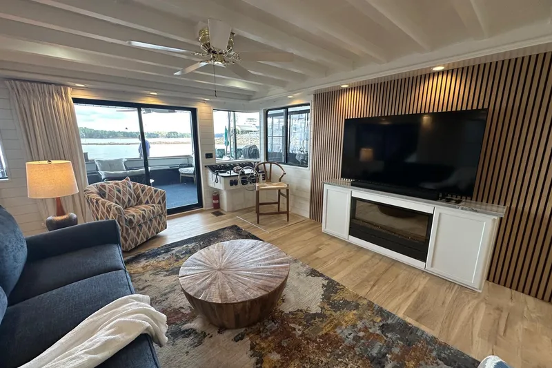 Slide: The Image of Luxurious 1998 Stardust Cruisers 16x84 houseboat interior with modern decor and large TV. - 3