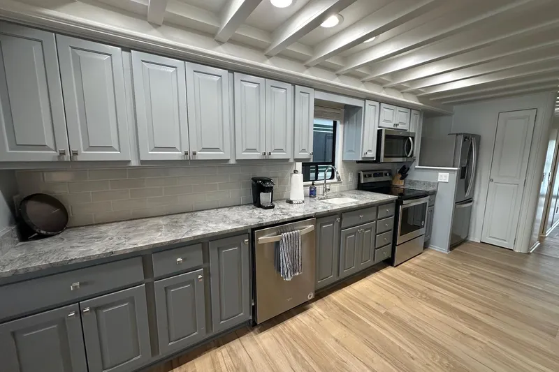 Slide: The Image of Modern kitchen in 1998 Stardust Cruisers 16x84 houseboat with gray cabinets and stainless steel appliances. - 4