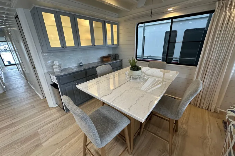 Slide: The Image of Luxurious dining area in a 1998 Stardust Cruisers 16x84 houseboat with modern decor. - 6