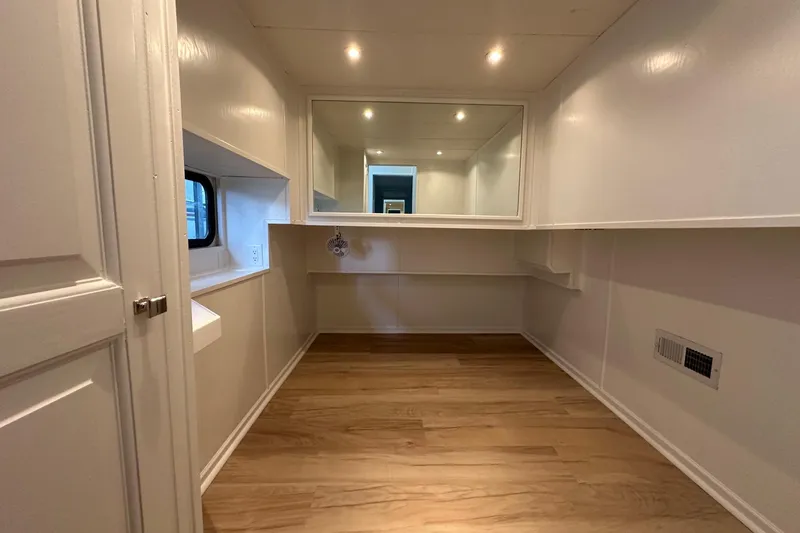 Slide: The Image of Interior of 1998 Stardust Cruisers 16x84 houseboat with wood flooring and white walls. - 8