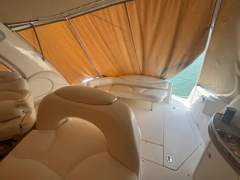 Slide: The Image of Interior of a 1999 Sea Ray 380 Sundancer yacht with beige seating. - 13