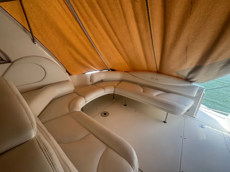 Slide: The Image of Interior of a 1999 Sea Ray 380 Sundancer with beige leather seating. - 14