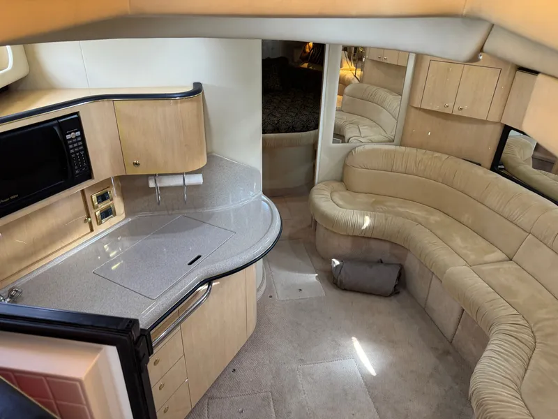 Slide: The Image of Interior of 1999 Sea Ray 380 Sundancer with kitchen and seating area. - 16
